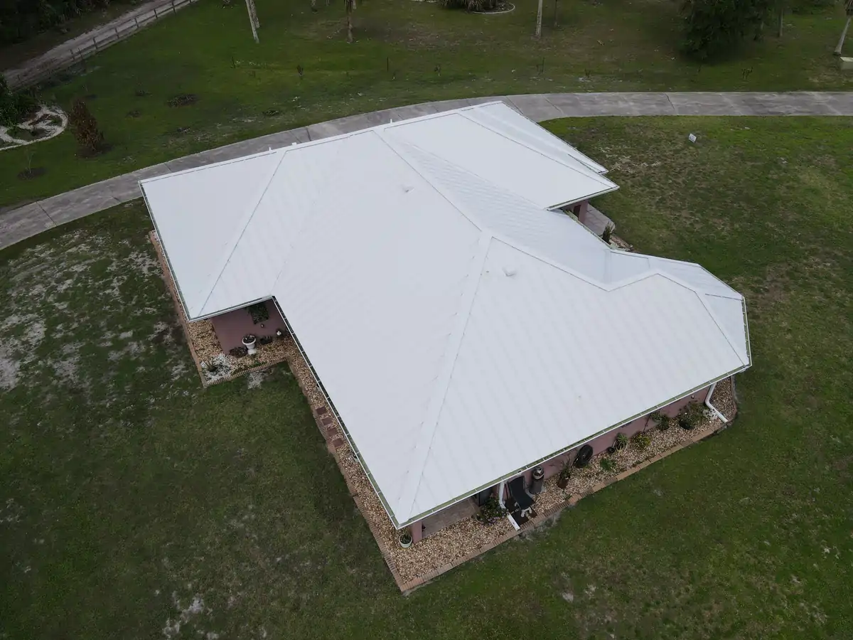 Drone rear view of the white metal roof on the Cocoa, Florida home