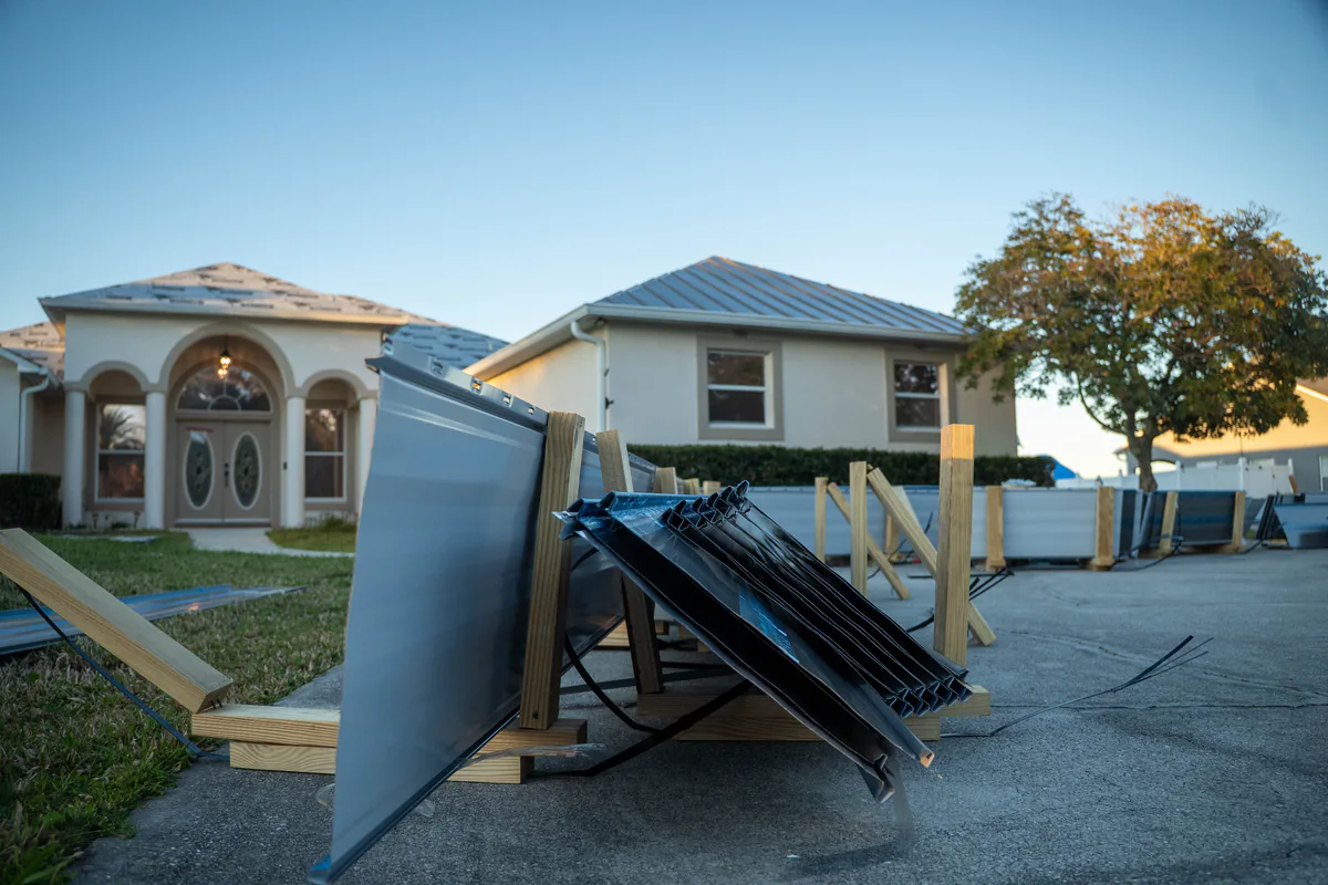Close view of the panels and trim stacked in the driveway of the Kissimmee home