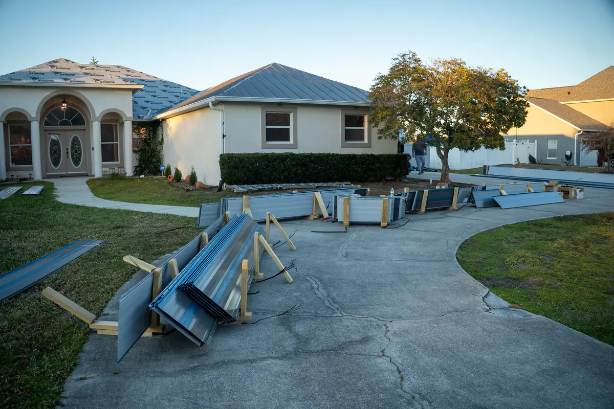 Panels laid out across the driveway with the Kissimmee home behind them