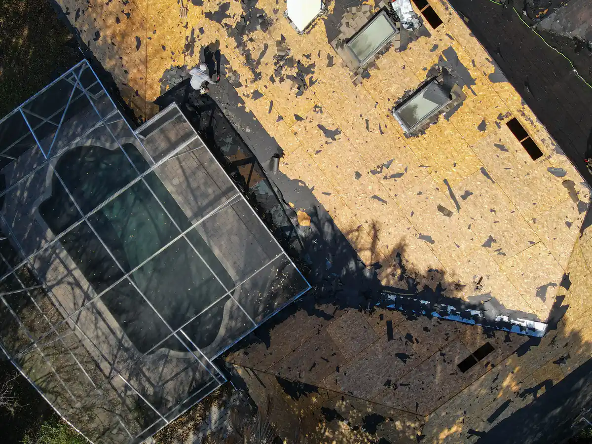 Overhead view of the exposed roof deck above the screened pool enclosure