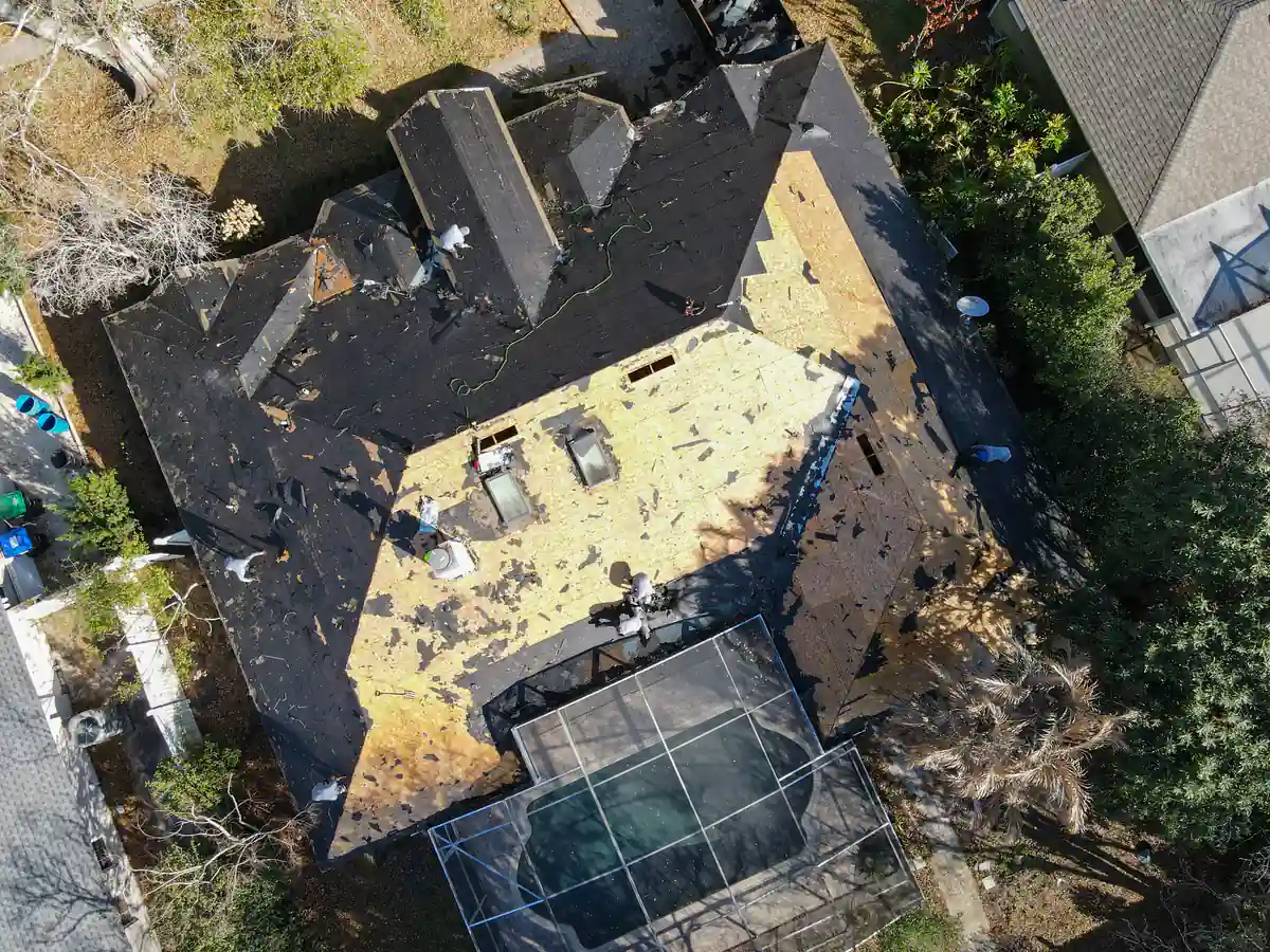 Overhead drone view of the Orlando roof mid tear-off, with sections of decking exposed